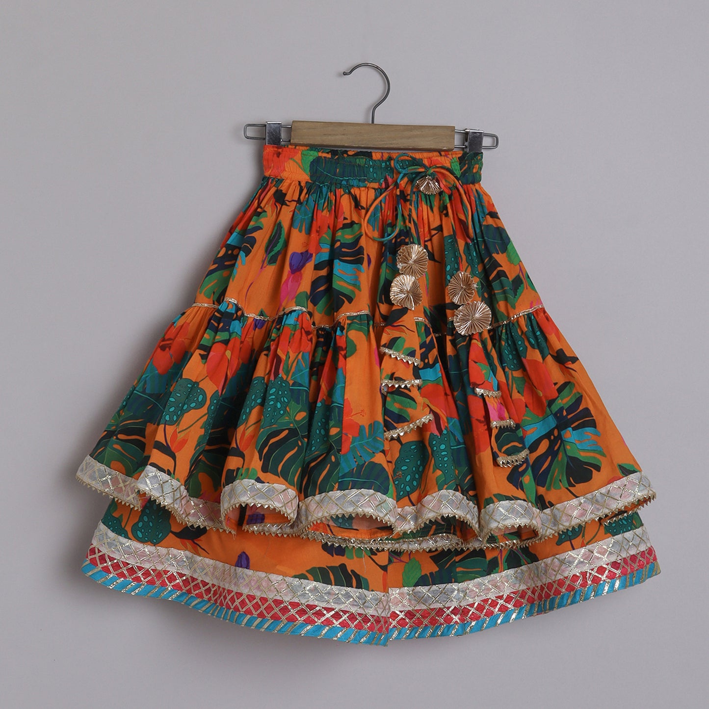 Girls Beautifully Crafted Orange Pleated Spaghetti Strap Top And Printed Layered Lehenga