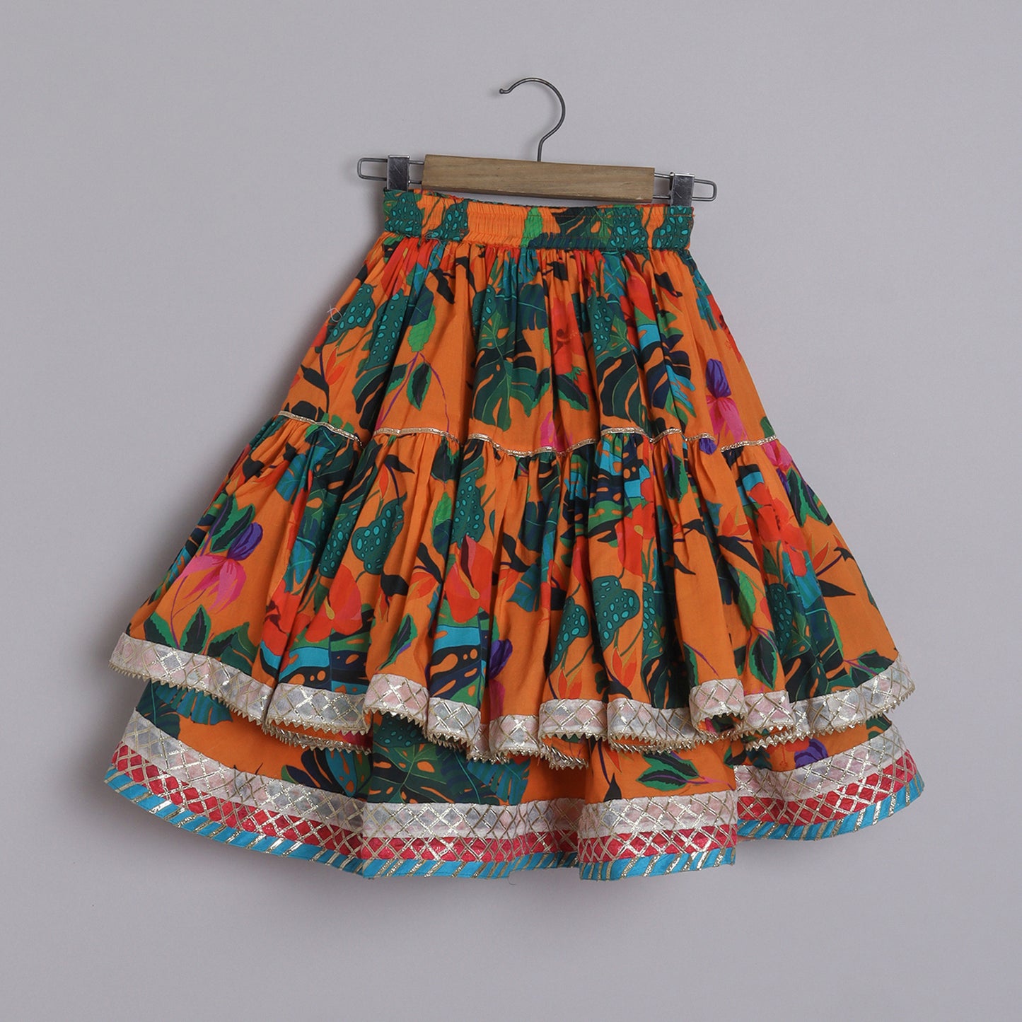 Girls Beautifully Crafted Orange Pleated Spaghetti Strap Top And Printed Layered Lehenga